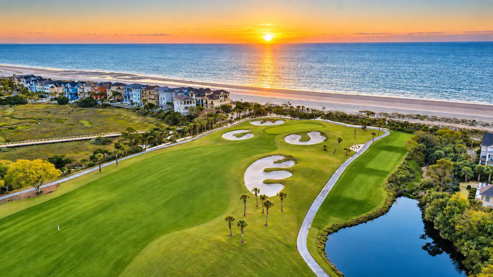 Green and bunkers with the ocean sunset behind